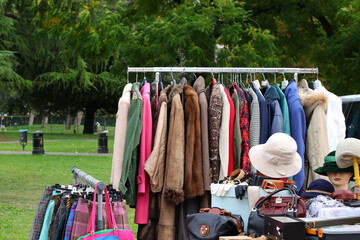vintage used and new clothes for sale in the stall stand at the flea market