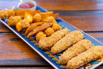 Fry fish finger and potato wedges