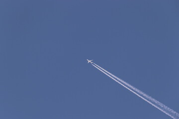 A jet in the sky with track behind