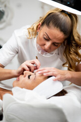 Woman Eye with Long Eyelashes. Beautiful Young Woman During Eyelash Extension.