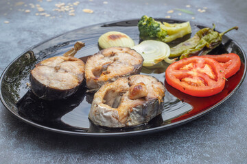 Bonito slices in a black plate