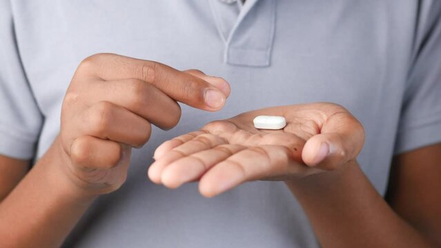 Close up of man hand holding pills with copy space 