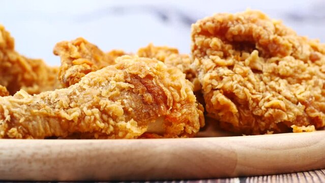 Crispy fried chicken wings on a plate top view .