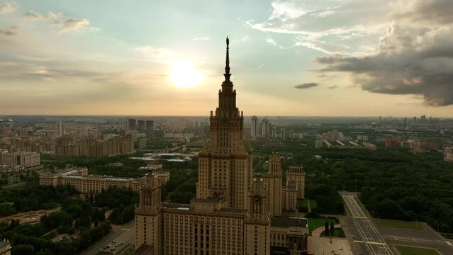 The main building of Moscow State University at sunset of a cloudy stormy sky. The famous Stalin high-rise, a monument of Soviet architecture against the background of the modern city.
