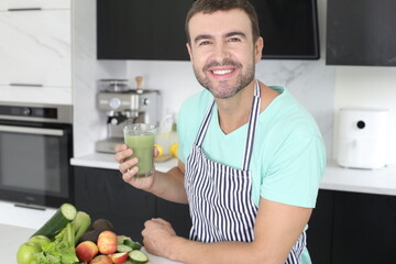 Man preparing a green juice with natural ingredients 