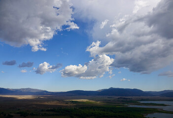 big sky with dramatic clouds above the valley and Lake Elsinore