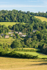 Obraz premium Early morning light on Midsummers Day (June 21st) on the Cotswold village of Slad, Gloucestershire, England UK 