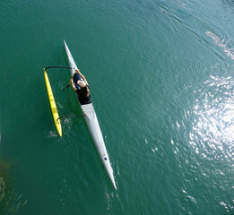 aerial view of person paddling outrigger in the bay