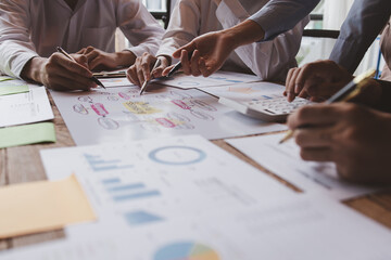 Financial analysts analyze business financial reports on a digital tablet planning investment...