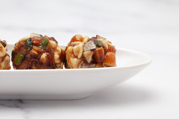 Close-Up Indian classical dry fruits and nuts laddoo (sweet or mithai) enriched with almond,...