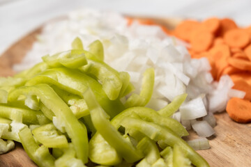 Chopped fresh peppers, onions, carrots. Vegetarianism concept. Mix of vegetables.