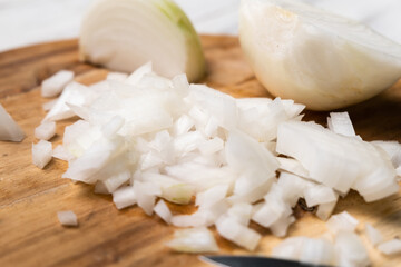 Fototapeta na wymiar Diced onion on a wooden cutting board. Sliced white onion.