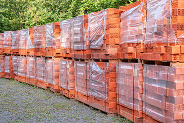 Pallets with bricks. Red ceramic block in stacks.