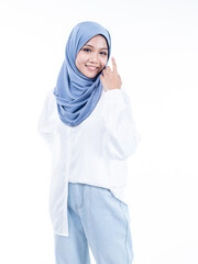 Half length portrait of a beautiful Muslim female model wearing modern and stylish casualwear with hijab isolated white studio background. Modern hijab fashion and beauty concept