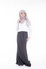 Fototapeta premium Portrait of Muslim woman in office attire and wearing a hijab. Asian woman in a corporate world. Formal corporate outfit and elegant appearance. Corporate or business people concept. Isolated