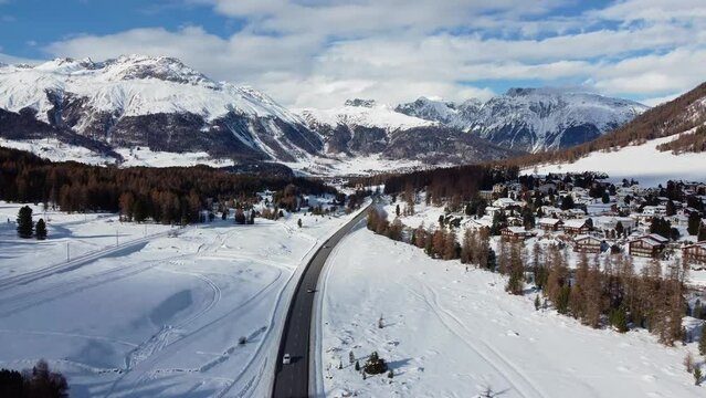 Pontresina, Switzerland: Aerial drone footage of the Bernina valley and the Pontresina village and ski resort town in Canton Graubunden in the Swiss alps in winter. 