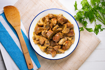 Braised pork with red wine sauce and mushrooms. Traditional northern Spanish tapas.