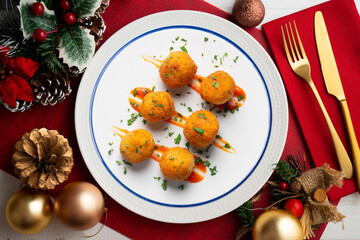 Tapa of Iberian ham croquettes. Recipe made with bechamel sauce and ham, all battered and fried in the shape of round balls.