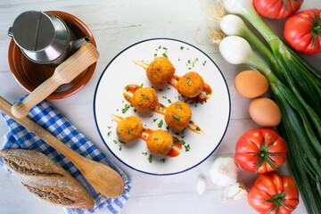 Tapa of Iberian ham croquettes. Recipe made with bechamel sauce and ham, all battered and fried in the shape of round balls.