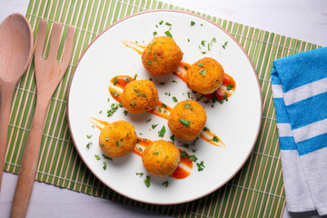 Tapa of Iberian ham croquettes. Recipe made with bechamel sauce and ham, all battered and fried in the shape of round balls.