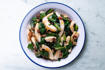 Cuttlefish cooked with chard and spinach. Spanish traditional tapas.
