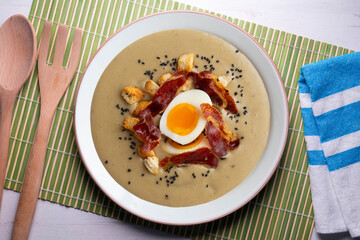 Smoked aubergine cream with crispy Iberian ham and boiled egg.