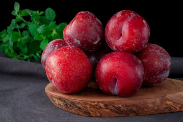 Fresh purple plum  on black background