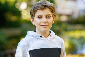 Portrait of preteen school kid boy. Beautiful happy child looking at the camera. Schoolboy smiling....