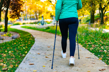 Nordic walking - woman training in city park
