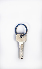 Apartment key on a metal ring, door key on a white background.