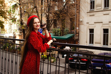 A girl in a red beret walks in the autumn city