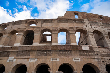 Colosseum against a blue sky with clouds. Italy, October 2022