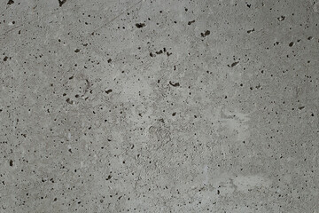 The abstract background is a concrete gray wall.