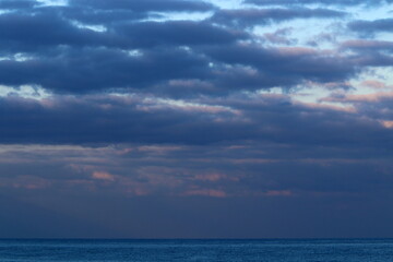 Large rain clouds in the sky over the sea.