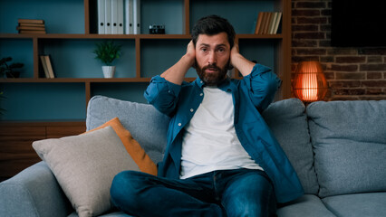 Fototapeta premium Stressed tired single father desperate about active difficult naughty playful girl child running at home exhausted dad babysitter cover ears avoid noisy disobedient kid nervous divorced man need rest