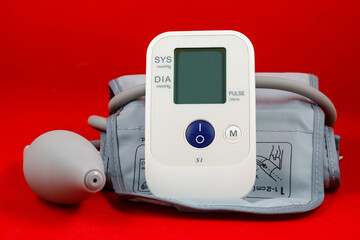 Blood pressure tonometer on a red background. Medical concept. Full depth of field.
