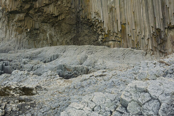 Columnar basalt rock, Cape Stolbchaty on Kunashir Island, in the foreground bases of lava basalt...