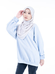 Portrait of a beautiful Muslim female model wearing modern and stylish casualwear with hijab isolated white studio background. Modern hijab fashion and beauty concept