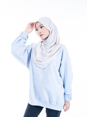 Portrait of a beautiful Muslim female model wearing modern and stylish casualwear with hijab isolated white studio background. Modern hijab fashion and beauty concept