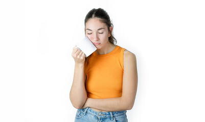 Young tired woman with a coffee mug. Exhausted worker/student. Isolated on white background.