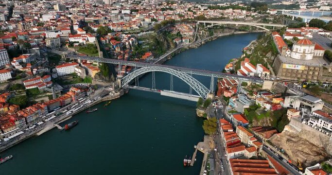Aerial view of Porto city in Portugal. Cityscape of downtown touristic Ribeira, old town, Douro river and Dom Luis I bridge during the sunny evening.