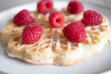 Dessert waffles with raspberries and bananas	