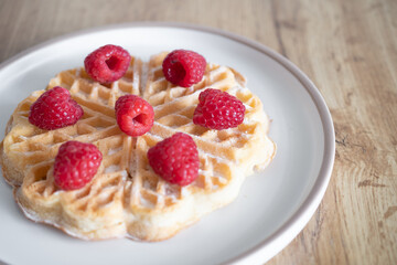 Dessert waffles with raspberries and bananas	