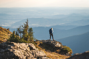 Mountain climbing. Woman hiker with backpack trekking in mountains