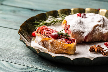 Strudel with a cherry. winter dessert strudel with cherry, cranberries and walnut. Food recipe background. Close up