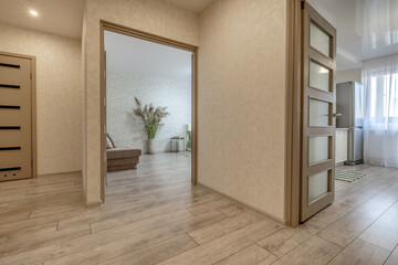 long empty corridor with doors in interior of entrance hall of modern apartments
