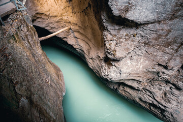 Aare Gorge canyon, blue alpine river between narrow rocky cliffs. Swiss Alps. Aareschlucht Meiringen Switzerland. Section of the river in the Bernese Oberland region o