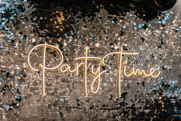 Text party time. Happy New Year 2023. Silver photo booth with decor shiny and led strips. Zone with sparkling sequins. Light blur background for wedding. A place for congratulations for birthday.