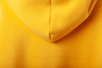 Autumn concept - yellow hoodie background, back view with hood
