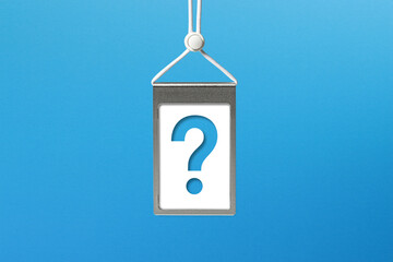 Business card with question mark suspended by rope on blue background	
